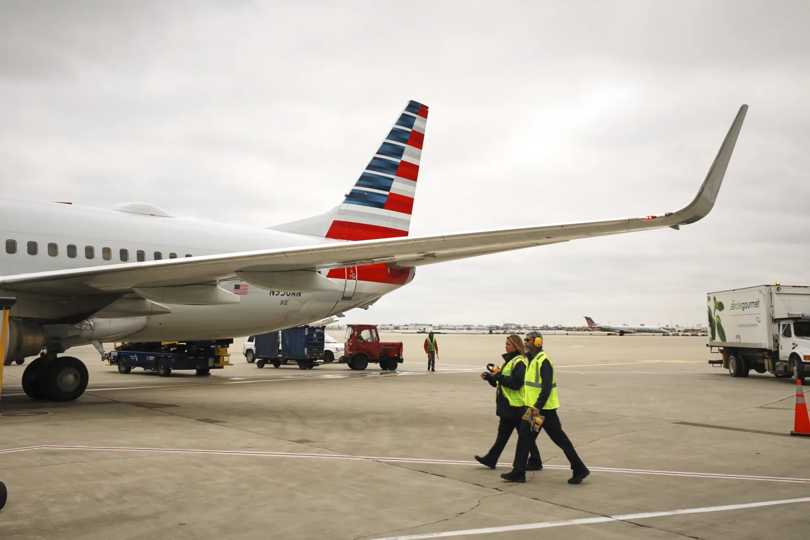 American Airlines widebody on stand, representing oneworld's North American backbone alongside Alaska Airlines.