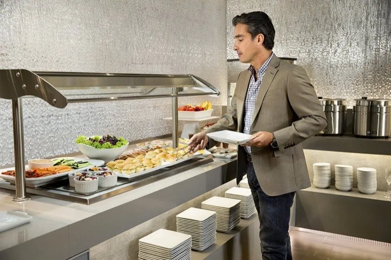 Airline lounge with dining and bar area for premium members